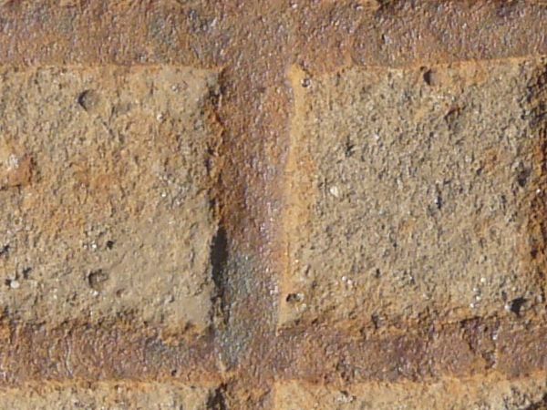 Seamless metal tread texture in brown tone with gridded pattern and very worn surface.